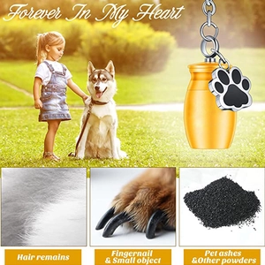 Golden cylinder cremation keychain for pets with paw charm and memorial storage view