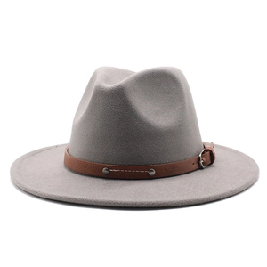 Detail of grey fedora hat featuring a brown leather band and metallic buckle accent
