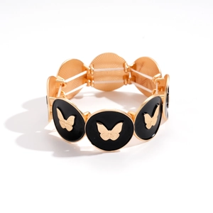 Vintage gold butterfly bracelet with black enamel circular links and elastic band