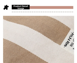 Detailed close-up of brown and beige striped canvas fabric with a stitched textile label