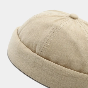 Close-up of beige docker hat showing high-quality cotton twill texture and neat stitching