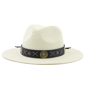 Detail of bohemian straw hat crown featuring black band with metal discs and gray stitching