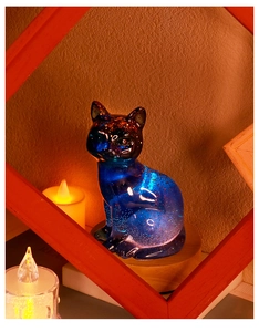 Cat resin craft with blue starry effect and glitter inside on a wooden base
