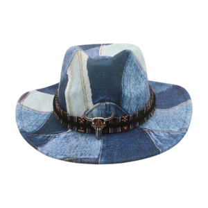 Detail of blue denim patchwork cowboy hat with ethnic braided band and silver bull head