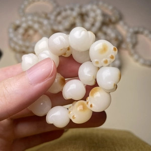 Handcrafted Bodhi seed bracelet featuring a cute cat paw bead design in creamy white finish