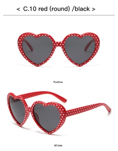 Front and 45-degree angle views of red heart-shaped sunglasses with white polka dots