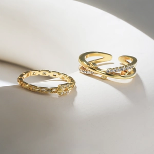 Detail of minimalist gold-plated adjustable rings with sparkling pavé cubic zirconia