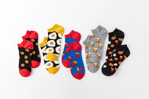Flat lay of five cotton no-show socks with colorful food patterns like burgers and fries