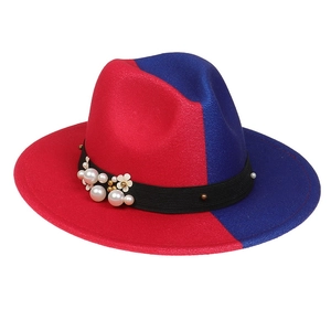 Detail of red and blue wool felt jazz hat featuring black ribbon with pearls and flowers