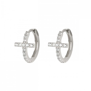 Silver huggie hoop earrings with crystal-encrusted cross pendant on white background