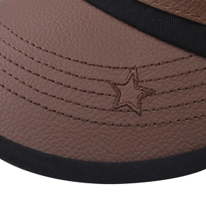 Macro detail of brown leather sun visor with parallel stitching and star embroidery