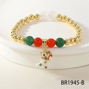 Detail of Christmas bracelet with gold, red, green beads and a white enamel stocking charm
