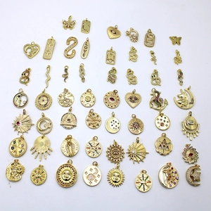 Golden 18K plated charms in various shapes like stars and moons with colorful crystals