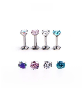 Macro shot of titanium steel labret studs with colorful round cubic zirconia in four colors