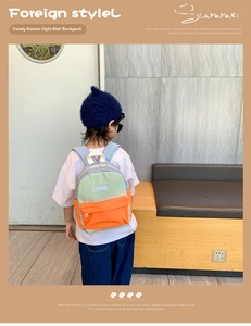 Detail of color-block toddler backpack with FASHION logo and secure front zipper pocket
