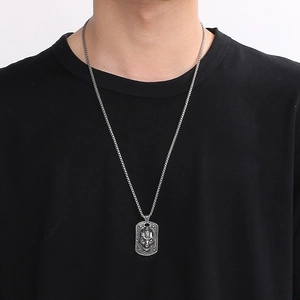 Retro gothic skull pendant necklace in vintage punk style for men on model