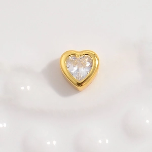 Macro shot of S925 sterling silver heart bead with hollow design and clear zircon inlay