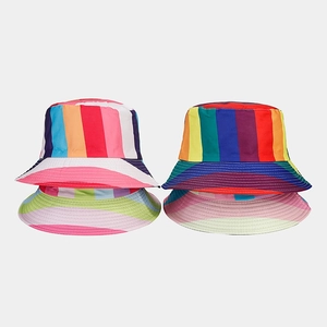 Close-up of vibrant rainbow striped reversible bucket hats in various colorful designs