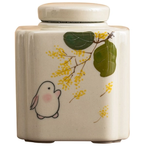 Hand-painted ceramic tea canister with rabbit and yellow flowers pattern in off-white finish