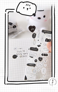 Detail of transparent PET decorative stickers with multilingual phrases for DIY planners