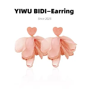 Detail of pink heart crystal earrings with large romantic fabric petal tassels