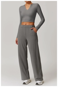 Front view of tight-fit yoga long sleeve V-neck top and wide-leg trousers in dark grey