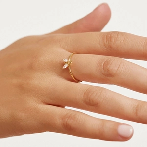 Detailed close-up of a minimalist gold bee ring with sparkling marquise-cut zircons