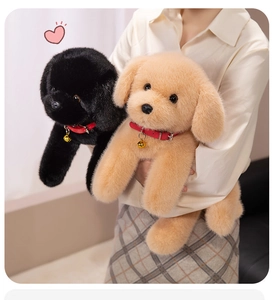 Detail of soft black and golden plush Labrador puppies with red bell collars