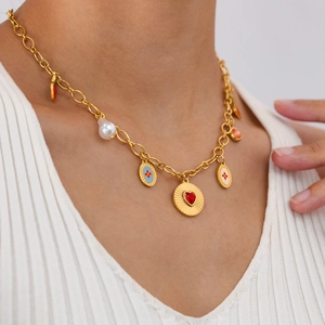 Gold chain necklace with strawberry, cherry, and colorful enamel charms on model