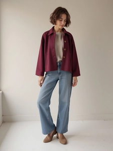 Classic burgundy short jacket styled with blue jeans and beige top for an autumn look