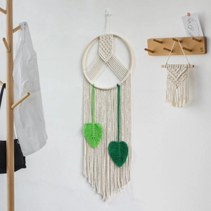 Minimalist macrame peace sign wall hanging with beige cotton rope and green leaf tassels