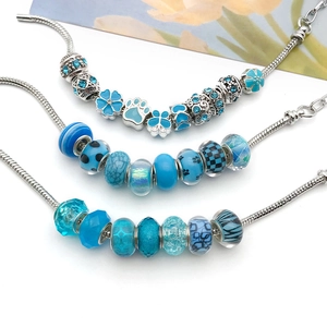 Three lake blue DIY beaded charm bracelets featuring silver snake chains and crystal beads