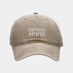 Close-up of Perfectly Imperfect embroidery on vintage washed khaki baseball cap