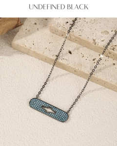 Detail of S925 silver capsule pendant with blue stones and gun-black finish