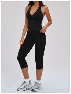 Detail of black halter V-neck sports vest and cropped leggings set for fitness yoga