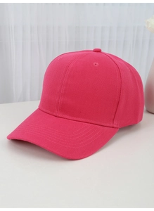 Macro shot of rose red cotton baseball cap on white surface showing fabric texture