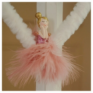 Detail of pink feather skirt ballet girl ornament with golden hair and resin body