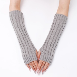 Close-up of light gray cable knit arm warmers showing soft wool texture and patterns