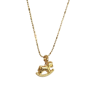 Elegant gold horse pendant necklace for women in a vintage minimalist aesthetic