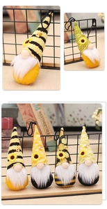 Set of four plush bee festival gnomes with yellow stripes and sunflower details