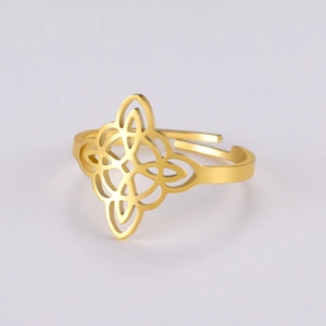 Macro detail of golden stainless steel hollow witch knot ring with celtic design