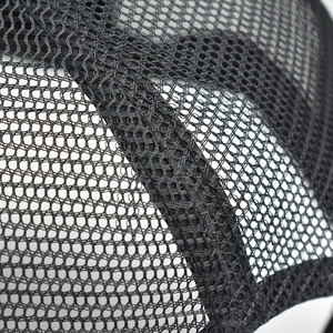 Close-up of black breathable hexagonal mesh and reinforced stitching on a trucker hat