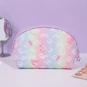 Detail showing rainbow gradient makeup bag with star zipper and dimensions 22.5x14x8cm