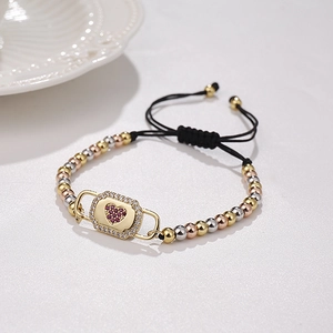 Detailed macro view of heart-shaped zircon charm on adjustable Milan rope bracelet