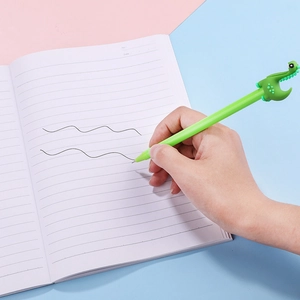 Cute green dinosaur gel pen for writing in a notebook on a colorful background