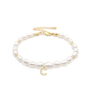 Macro view of natural freshwater pearl bracelet with zircon-set letter C pendant