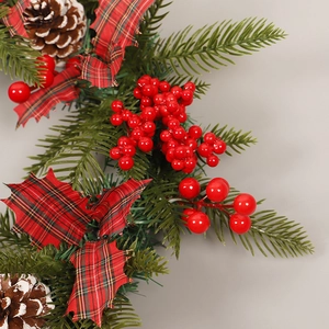 Christmas wreath with pine cones, red berries, needles and checkered leaves decoration