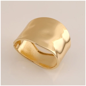 Detail shot of golden wide cuff bracelet featuring a brushed metal finish and hinge closure
