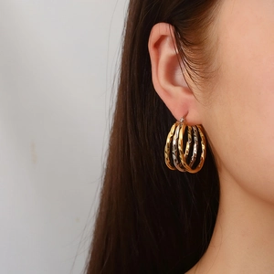 Three-tone twisted hoop earrings in gold, silver, and rose gold finishes for women