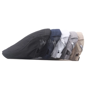 Detail showing mesh fabric and adjustable side buckles on multi-colored newsboy caps